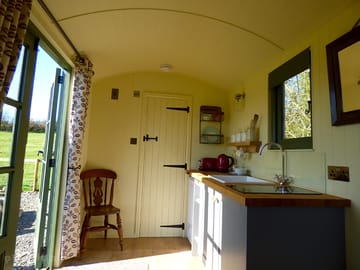 The kitchenette has a two-ring electric hob, toaster, kettle, full-size fridge and cooking equipment