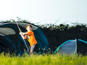 Campers enjoying the use of bats and balls provided on site