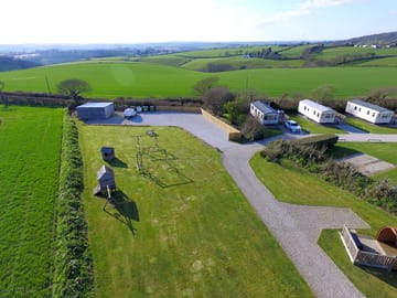 Grass area with traditional play equipment and suitable for ball games