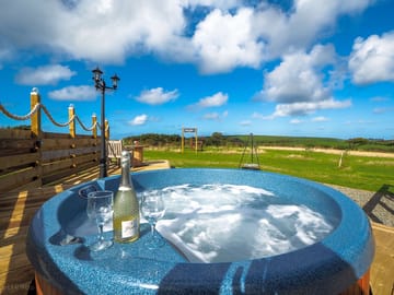 Relax in your own private hot tub and enjoy the views.