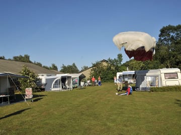 Paraglider landing at the site