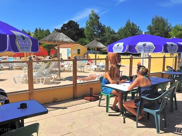 The bar terrace overlooks the swimming pool