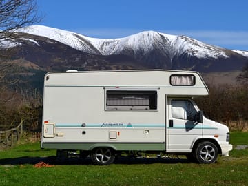 Motorhome pitch with snowy skiddaw behind
