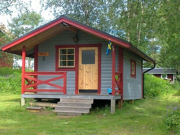 Wooden lodge under the trees