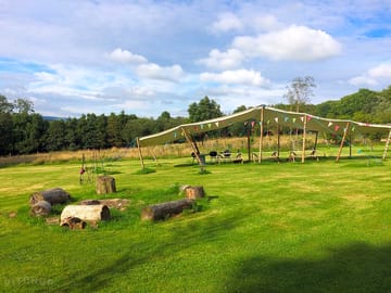 Pretty camping meadow surrounded by woodland