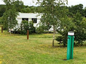 Serviced pitch surrounded by greenery