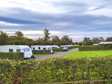 Peaceful setting with coastal views from some touring pitches