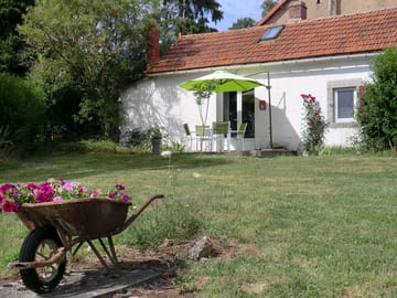 Cottage with outdoor seating and lawn