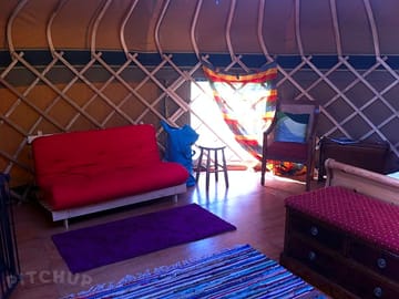 20ft yurt seating near window.