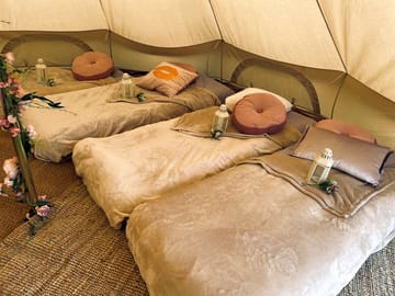 Bell tent interior - bed linen can be hired, or bring your own