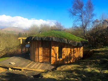 The wooden yurt settling into the rolling hills