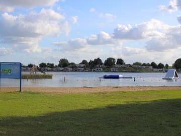 The site is on a swimming lake with its own private beach