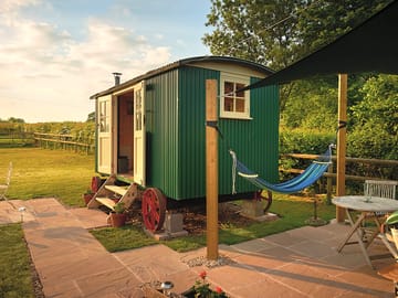 Patio, sail shade and hut with double doors open