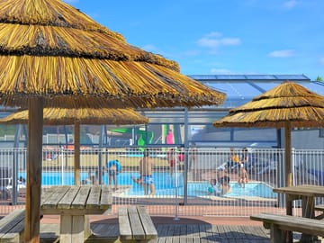 Picnic benches beside the pool area