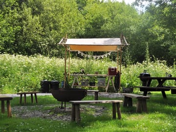 View of kitchen area, fire pit and picnic bench at geodome