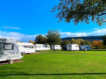 Grass pitches with views to forested hills