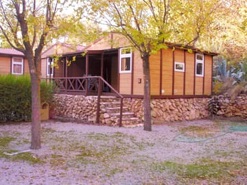 Lodges with a double bedroom, sitting room with a double sofa bed, kitchenette and bathroom