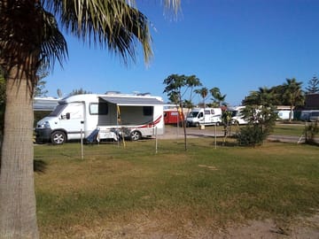 Open grass pitch with optional electricity for caravans and motorhomes