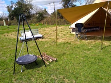 Fire pit and tripod outside the bell tent