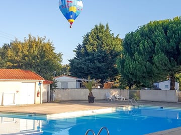 Hot air balloon over the pool