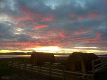 Pods under a red sky at dawn