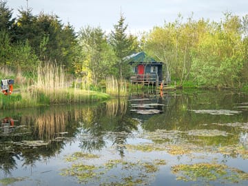 The fishing hut provides a place for guests to socialise. the pond is fully stocked with trout.