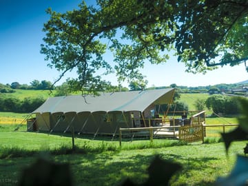 Tent in the meadow overlooking the farm and beyond