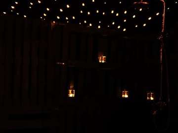 Romantic fairy lights and candles for secluded private outdoor bath & shower