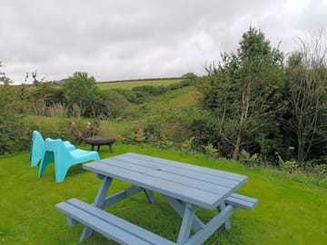 Private lawned area for bell tent, with firepit and picnic bench