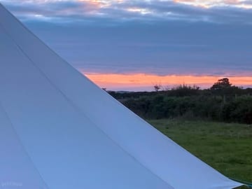 The sunset from behind the bell tents.
