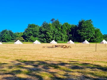 Bell tents and picnic area with firepit