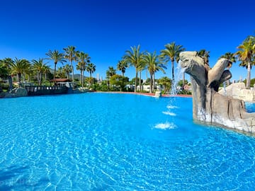 Lovely swimming pool surrounded by palm trees