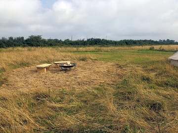 Meadow with firepit for additional tent pitch