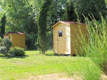 Premium pitch equipped with a fridge, microwave, outdoor furniture, and a parasol