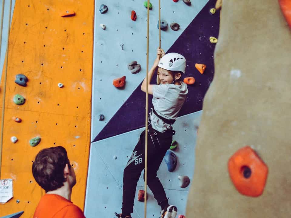 Child doing indoor rock climbing