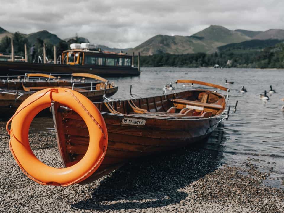 Small rowboat on shore of lake