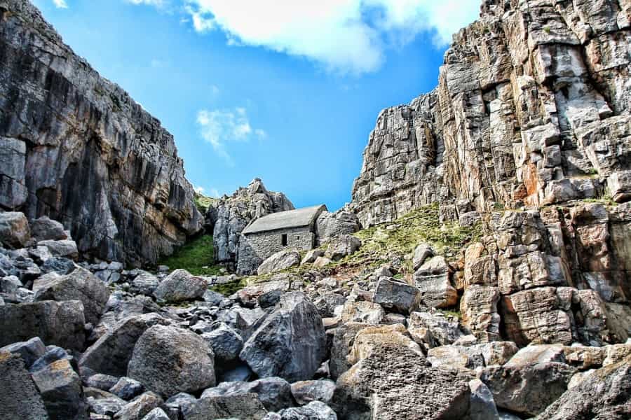 Tiny St Govan’s Chapel is built into the cliffs (Greg Montani/Pixabay)